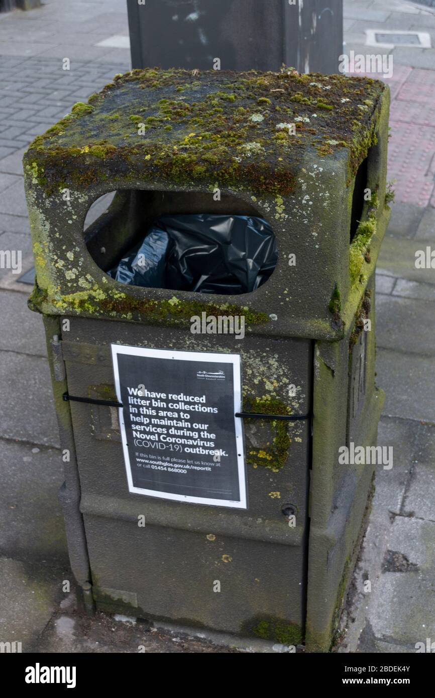 Bristol-April-2020-England-a close up view of public rubbish bin with mould and a Coronavirus-COVID 19 notice on the side Stock Photo