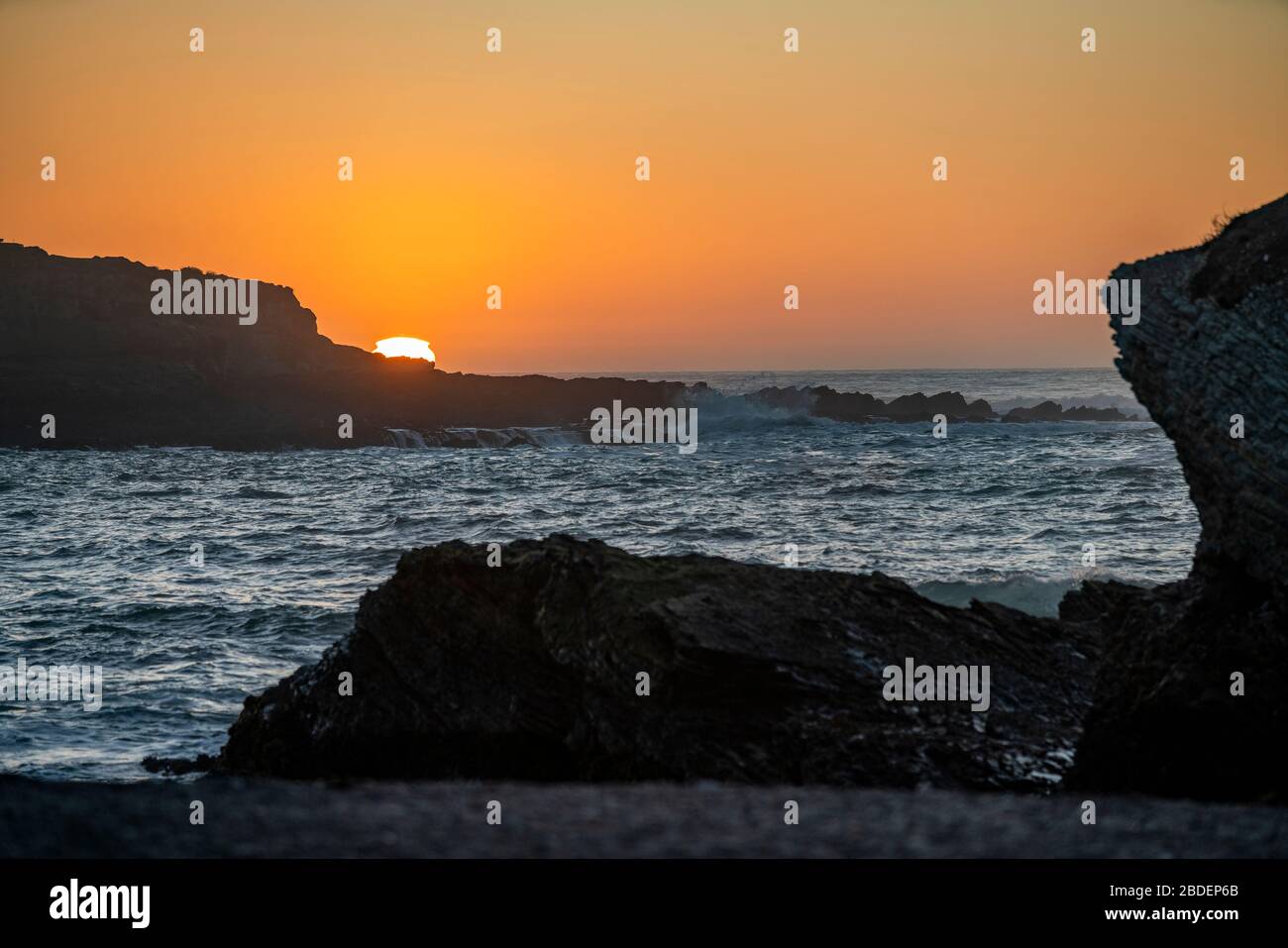 USA, California, San Luis Obispo, Sunset over sea cliff Stock Photo