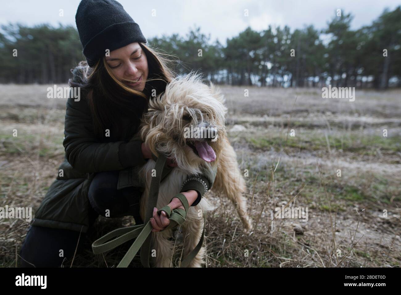 Young woman walking dog from animal shelterÂ Stock Photo
