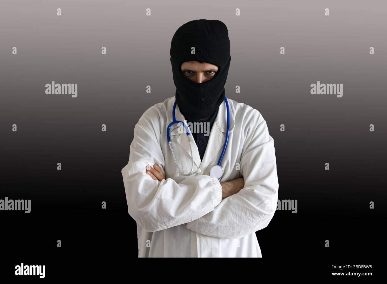 Doctor with thief mask isolated on black background. Medical malpractice concept. Stock Photo