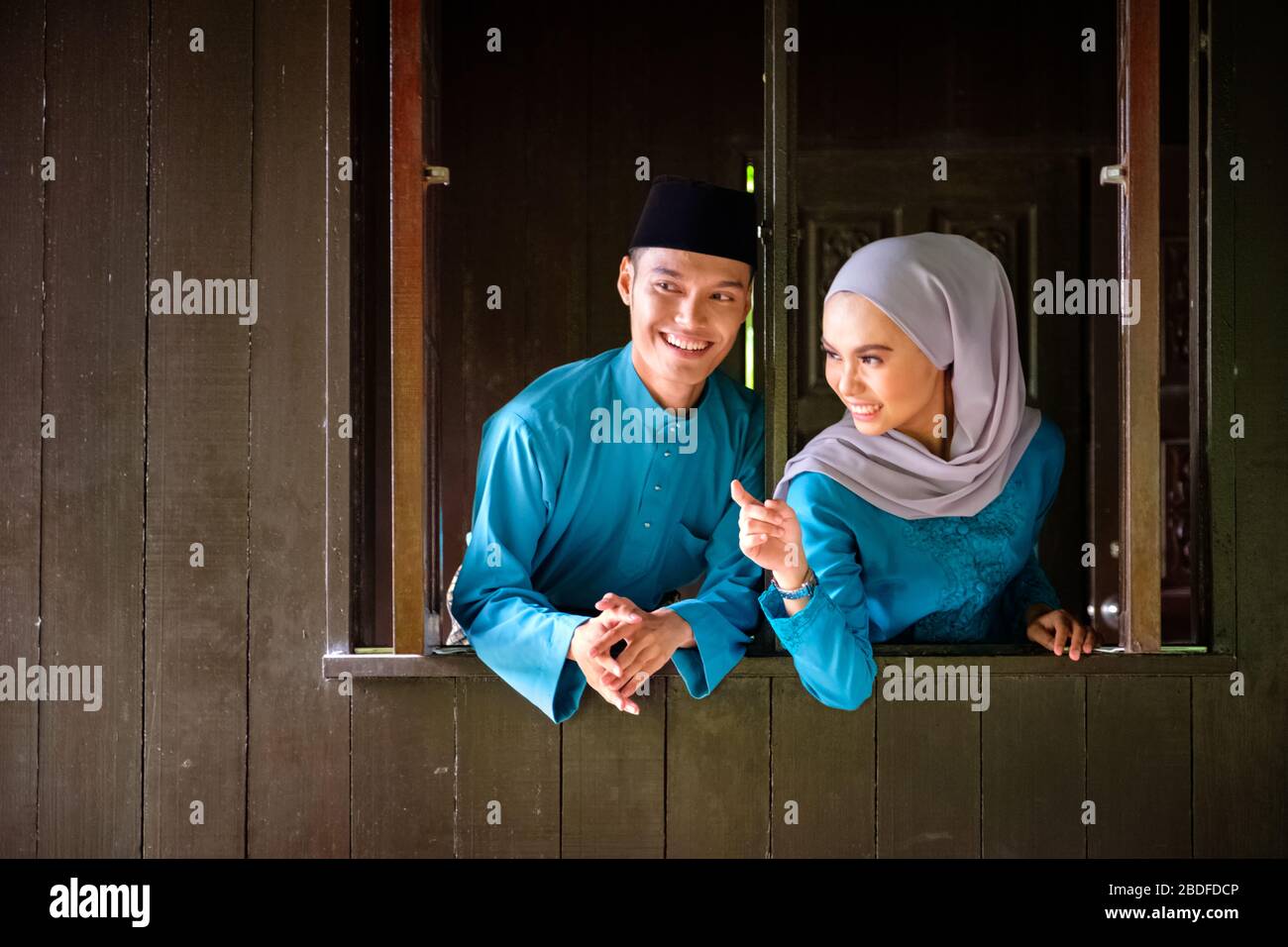 A portrait of young couple of malay muslim in traditional costume ...