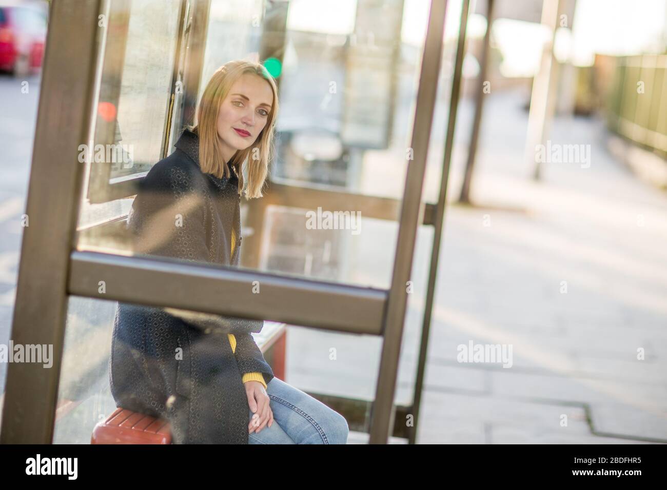 Woman waiting alone bus stop hi-res stock photography and images - Alamy