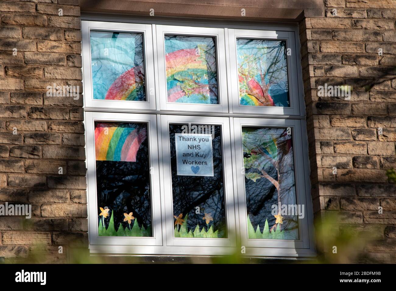 Rainbow of hope and thanks to NHS staff in window Stock Photo