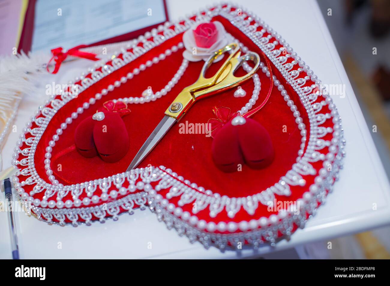 Wedding tradition . Golden rings in a red heart beautiful case . Pearls