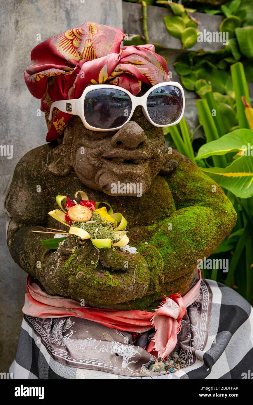 Vertical view of a dressed Bedogol statue at a temple in Bali, Indonesia. Stock Photo