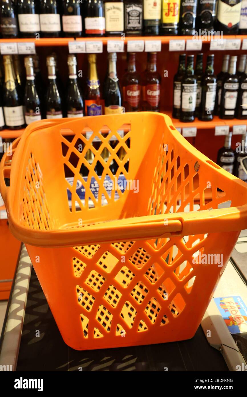 Panier de courses alimentaires en plastique orange déposé sur une caisse d'un supermarché. Saint-Gervais-les-Bains. Haute-Savoie. France. Stock Photo
