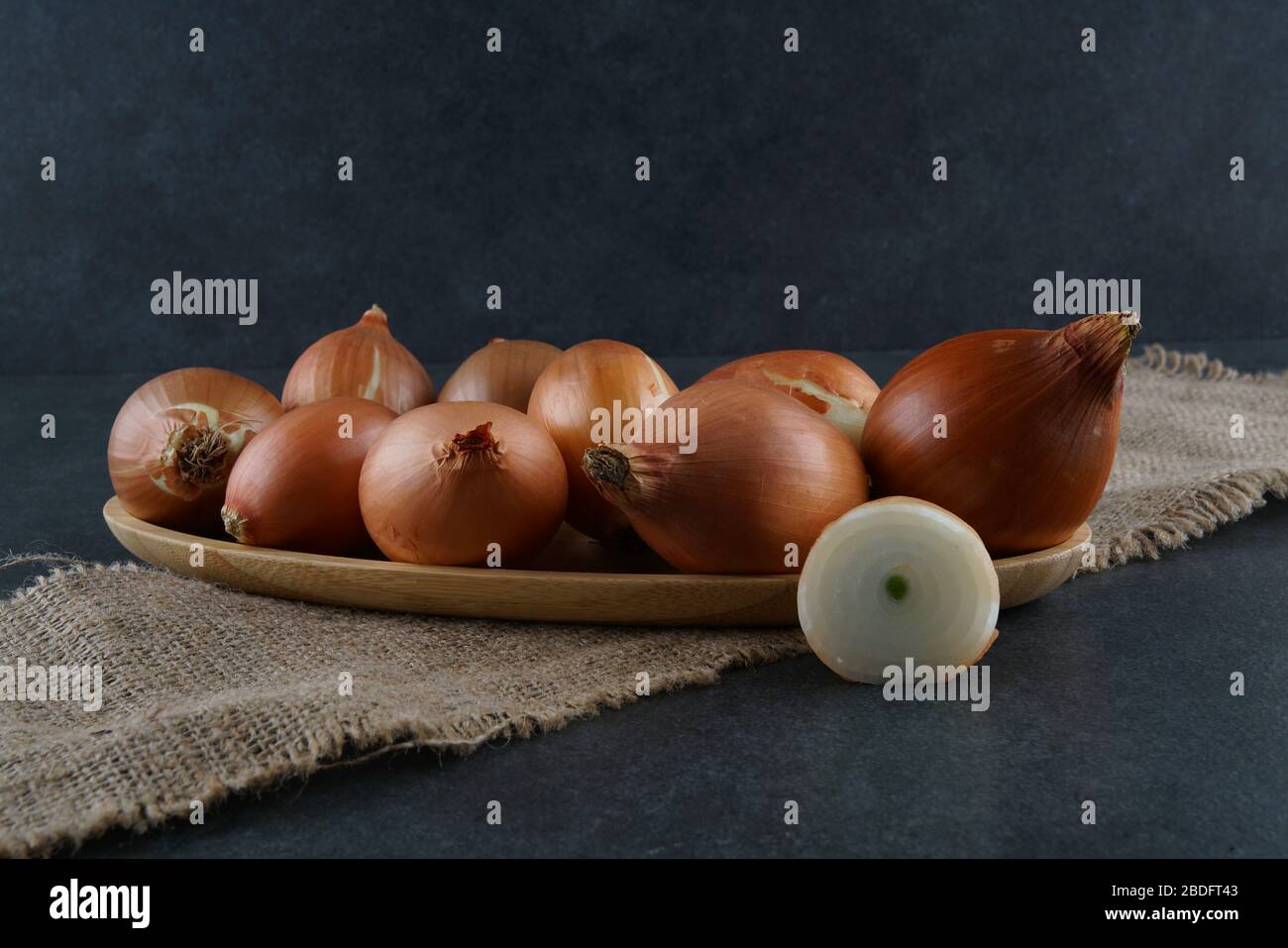 A group of onions on a dark background Stock Photo - Alamy