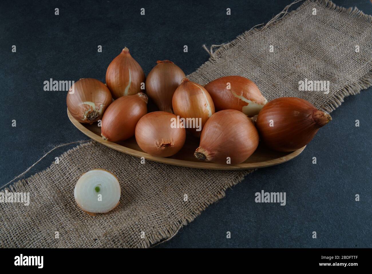 A group of onions on a dark background Stock Photo - Alamy