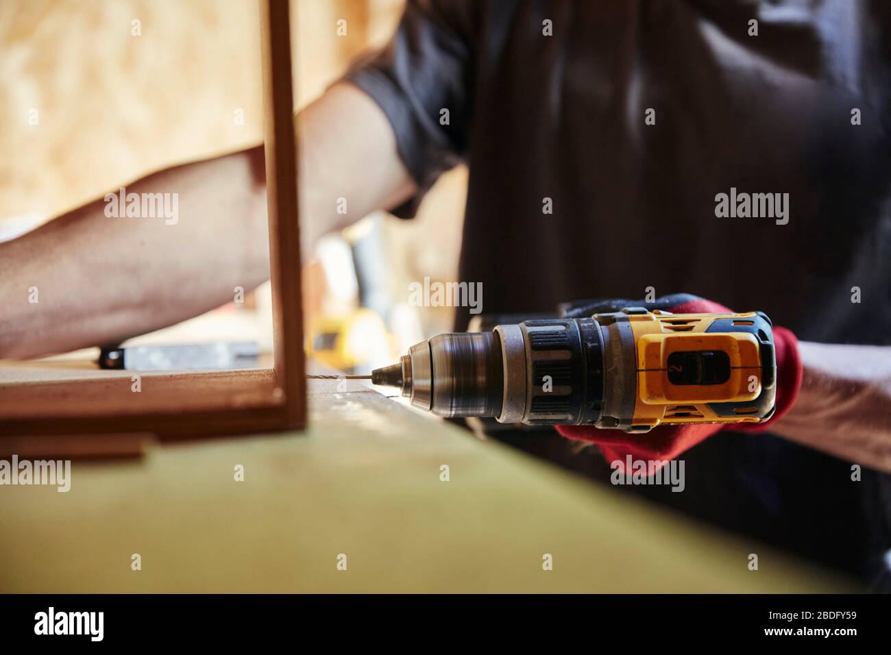Carpenter using a drill Stock Photo