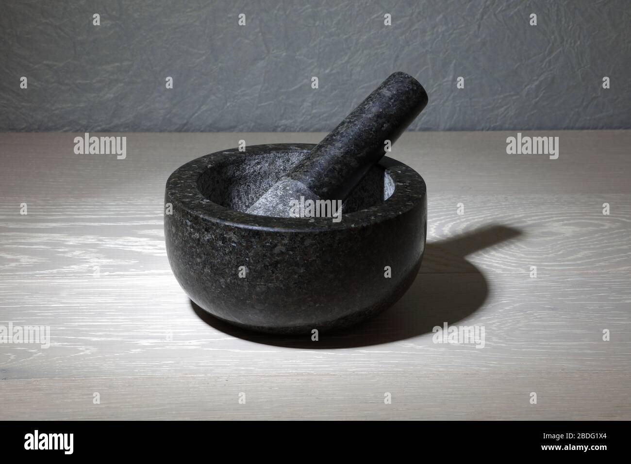 A mortar and pestle on kitchen work surface Stock Photo