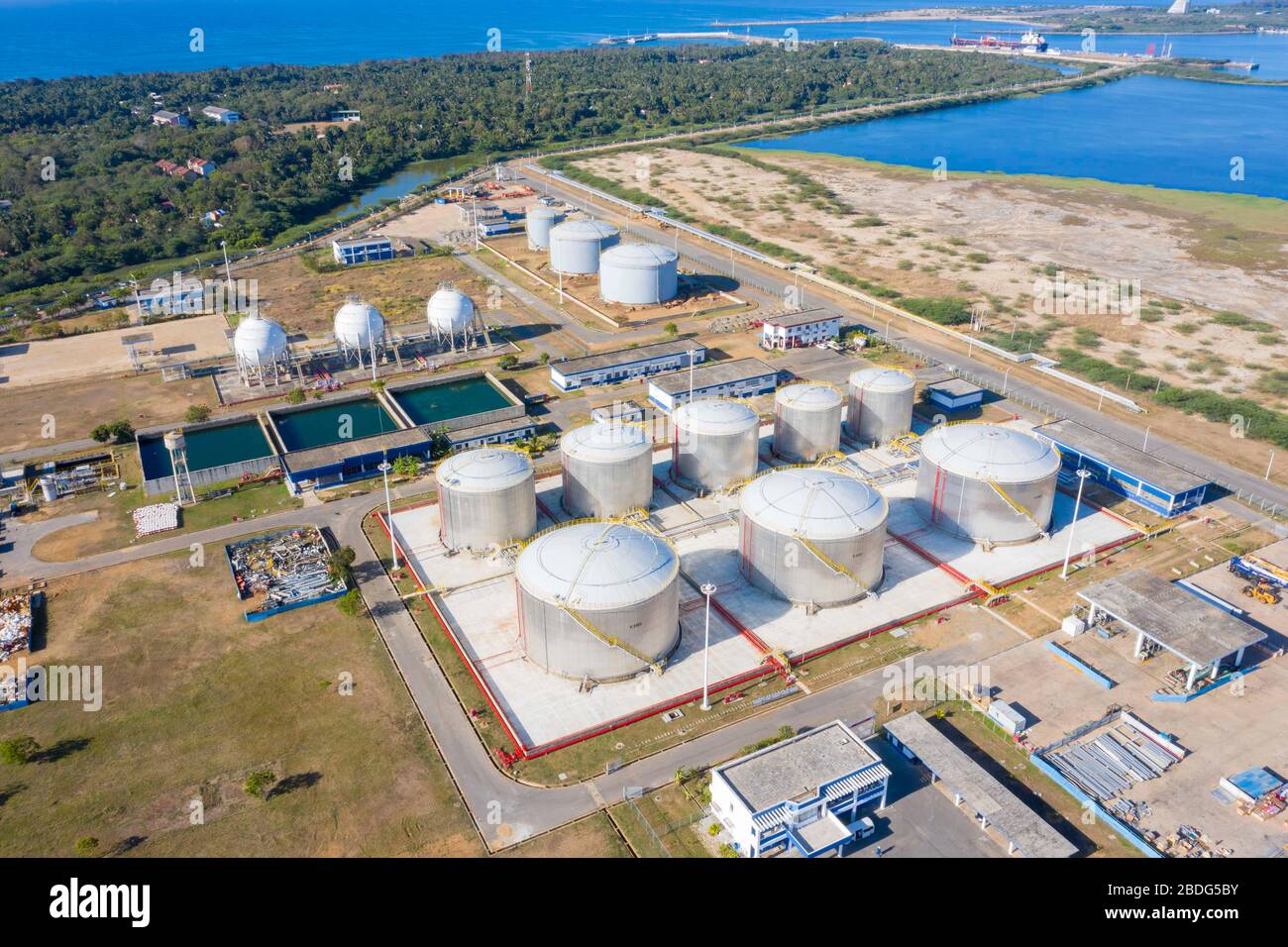 (200408) -- COLOMBO, April 8, 2020 (Xinhua) -- Aerial photo taken on April 6, 2020 shows oil tank area at Hambantota International Port, Sri Lanka. Sri Lanka-China joint venture, Hambantota International Port (HIP), is set to kick off fuel bunkering operations and support COVID-19 affected supply chains after a ship finished discharging low-sulphur fuel into the port's tanks on Tuesday afternoon. TO GO WITH:Sri Lanka's Hambantota port to support COVID-19 affected supply chains with low-sulphur fuel (Photo by Liu Hongru/Xinhua) Stock Photo