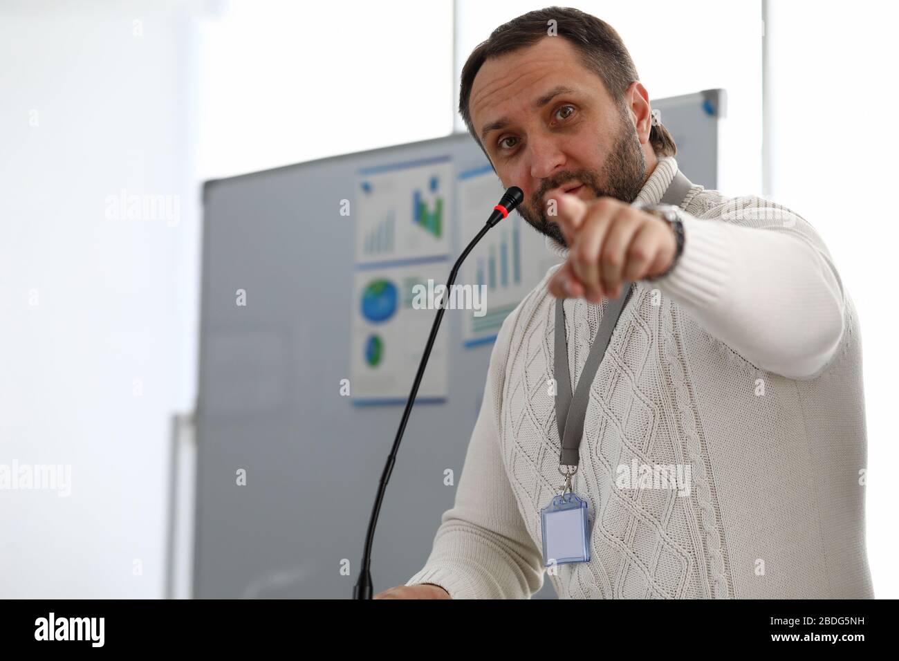 Male person speaking into microphone Stock Photo