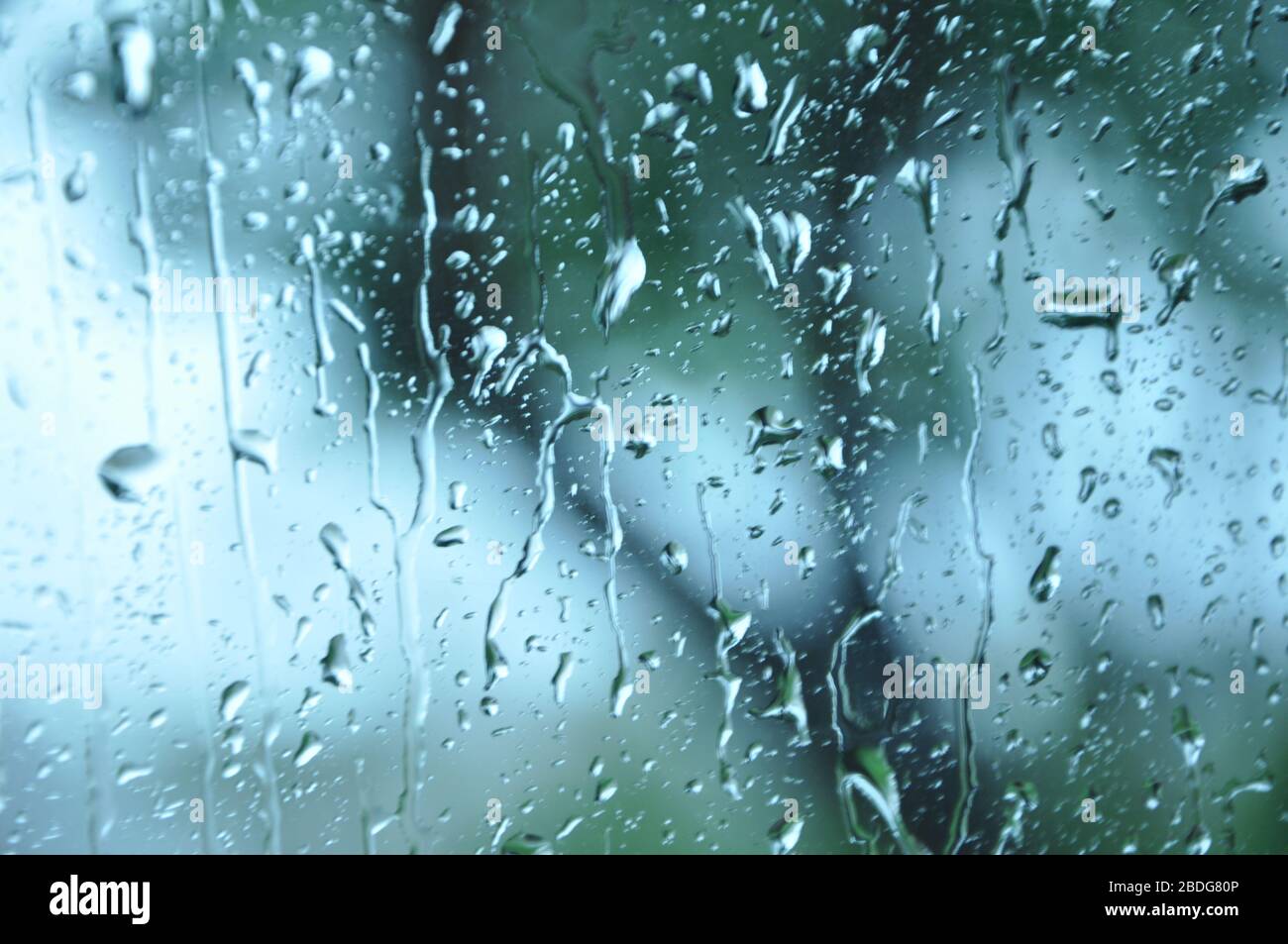 Blurred picture of traffic through a car window during heavy rain.Car