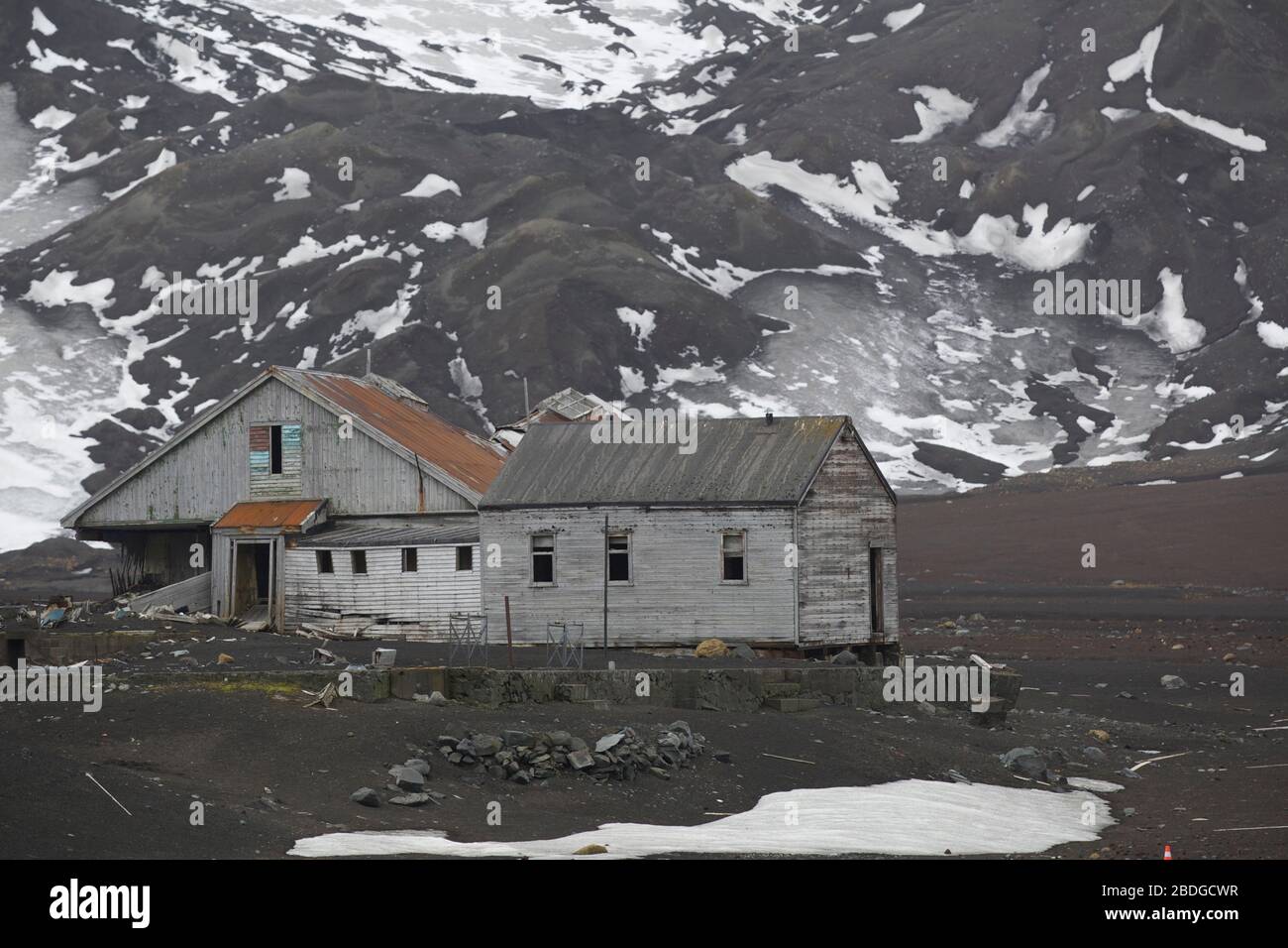 Whalers Bay Buildings in Front of Mountains Stock Photo