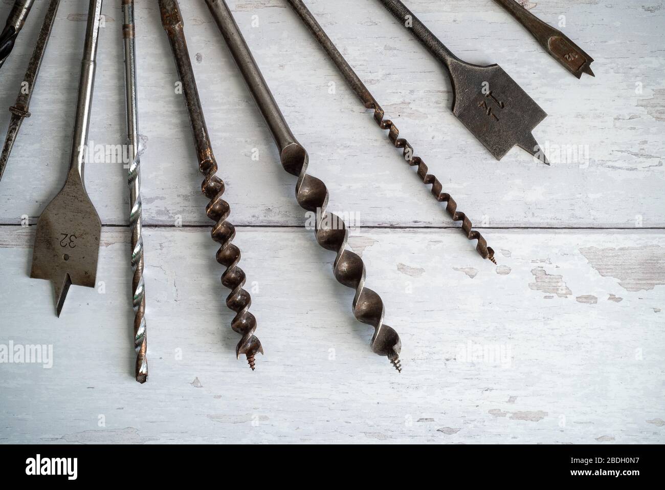 Vintage tools. Vintage drill bits against a white wooden background