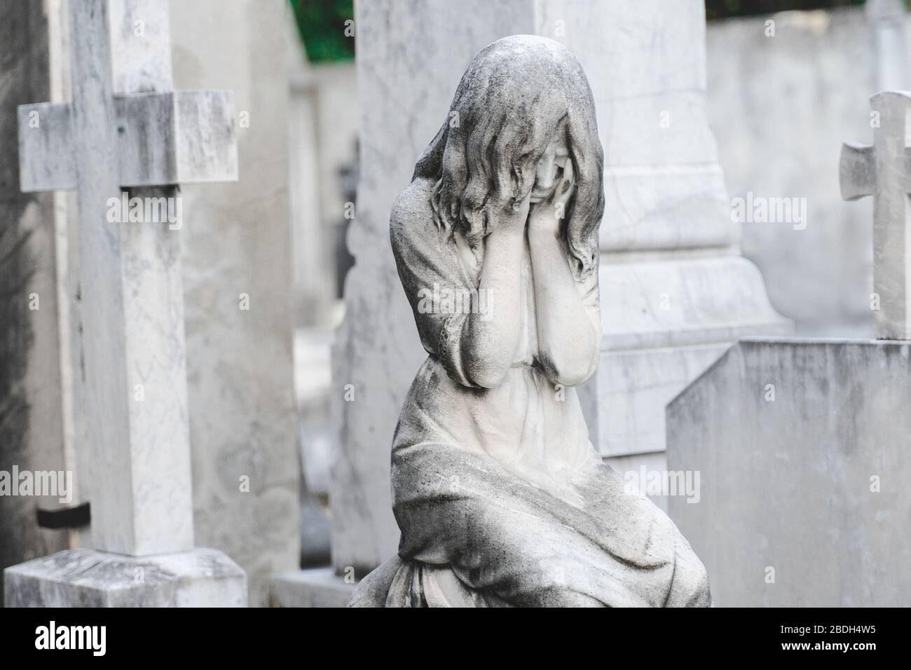sculpture of a angel girl in an old cemetery. Closeup of stoned angel