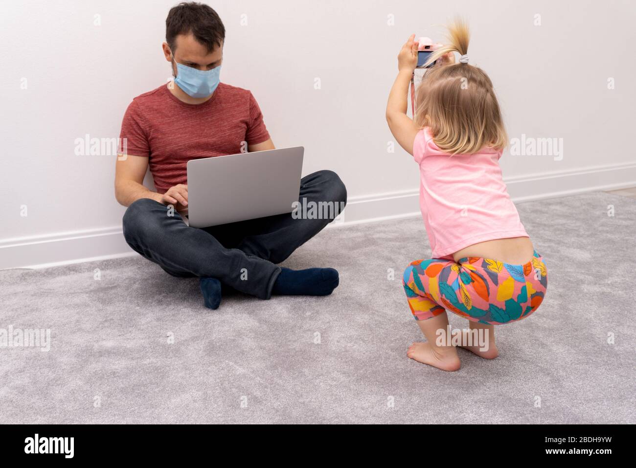Father works at quarantine and baby takes photos Stock Photo Alamy