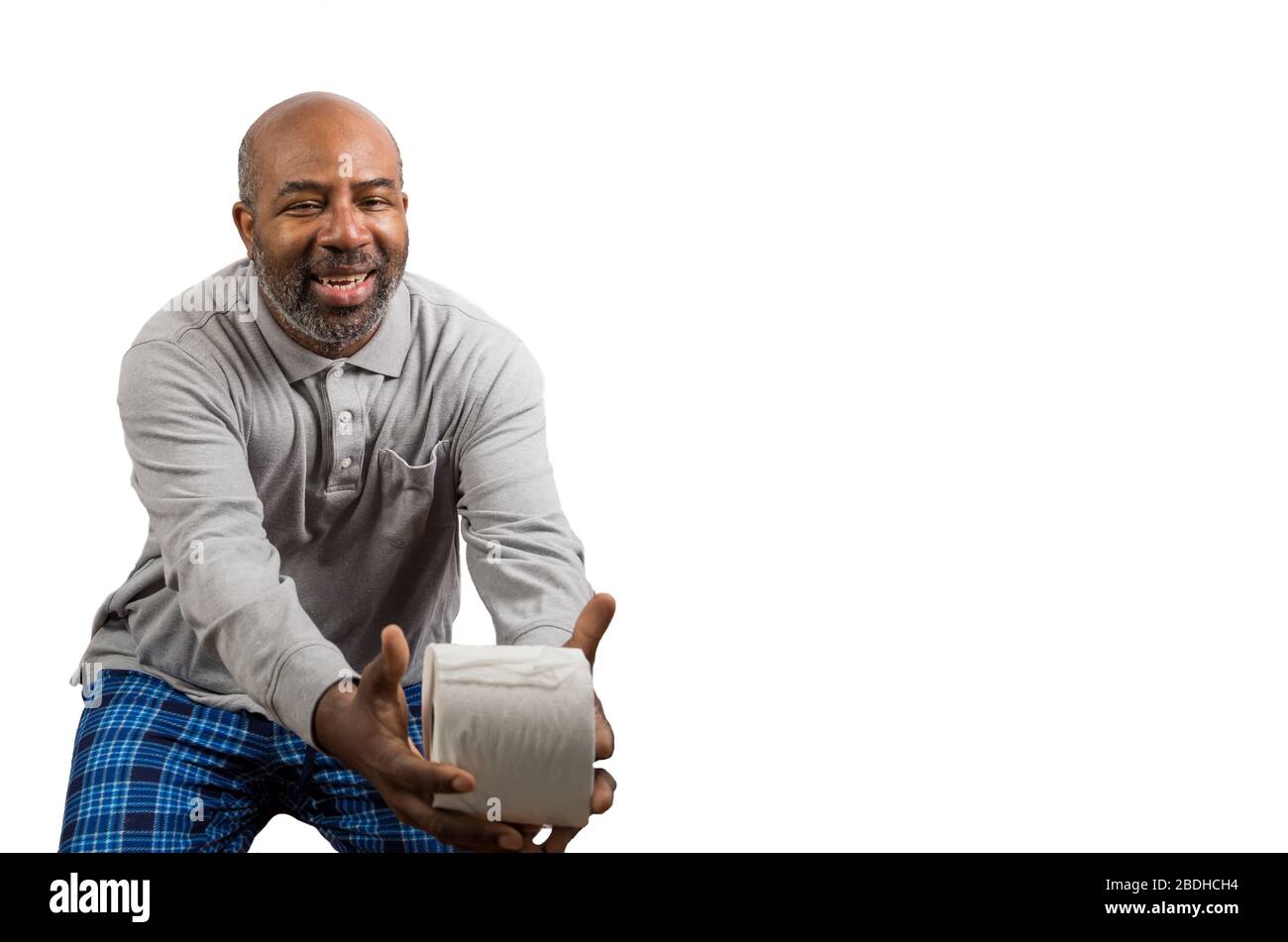 African American man with toilet paper during Corona Virus crisis. Dark Humor with copy space Stock Photo