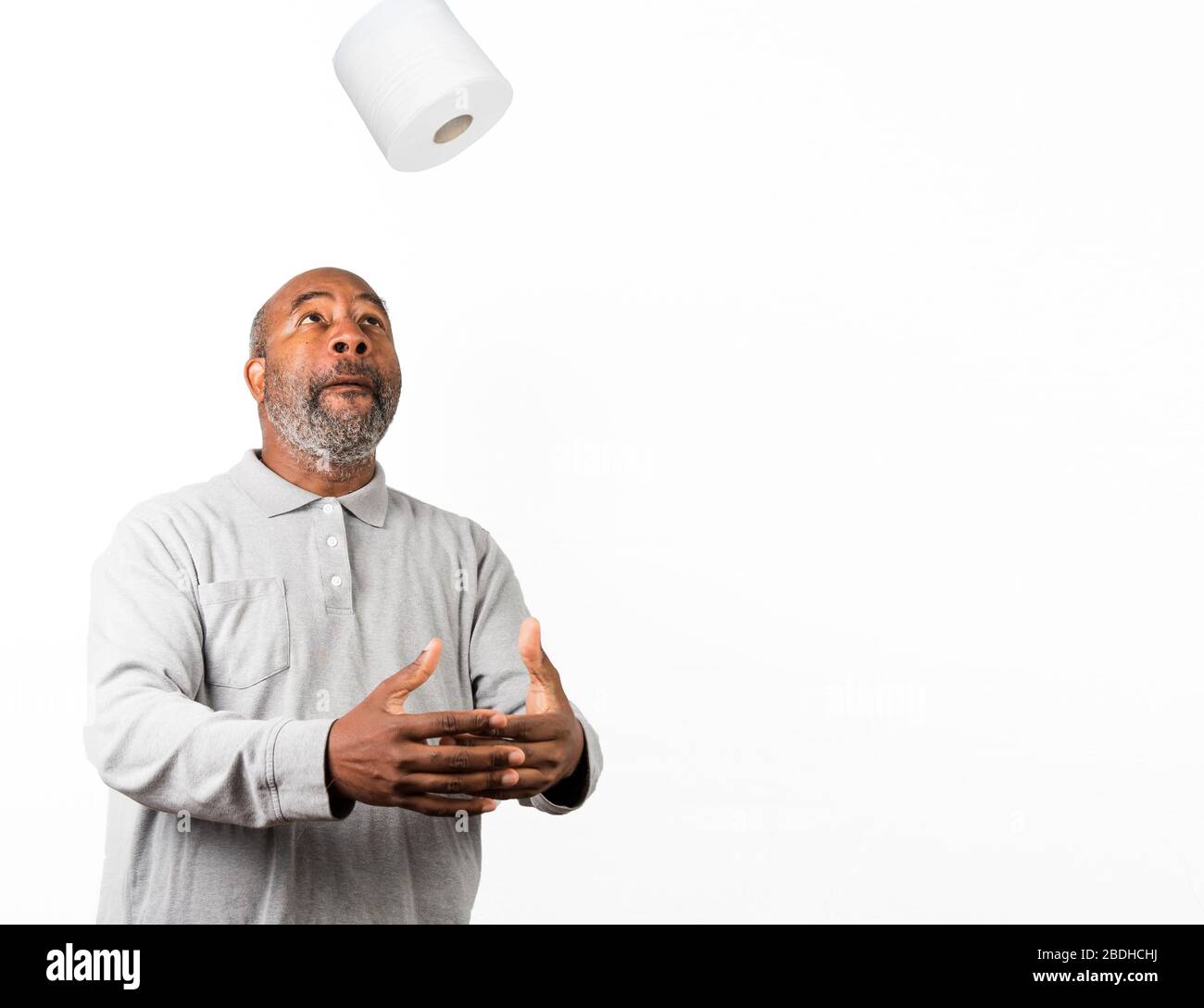 African American man with toilet paper during Corona Virus crisis. Dark Humor with copy spacc Stock Photo