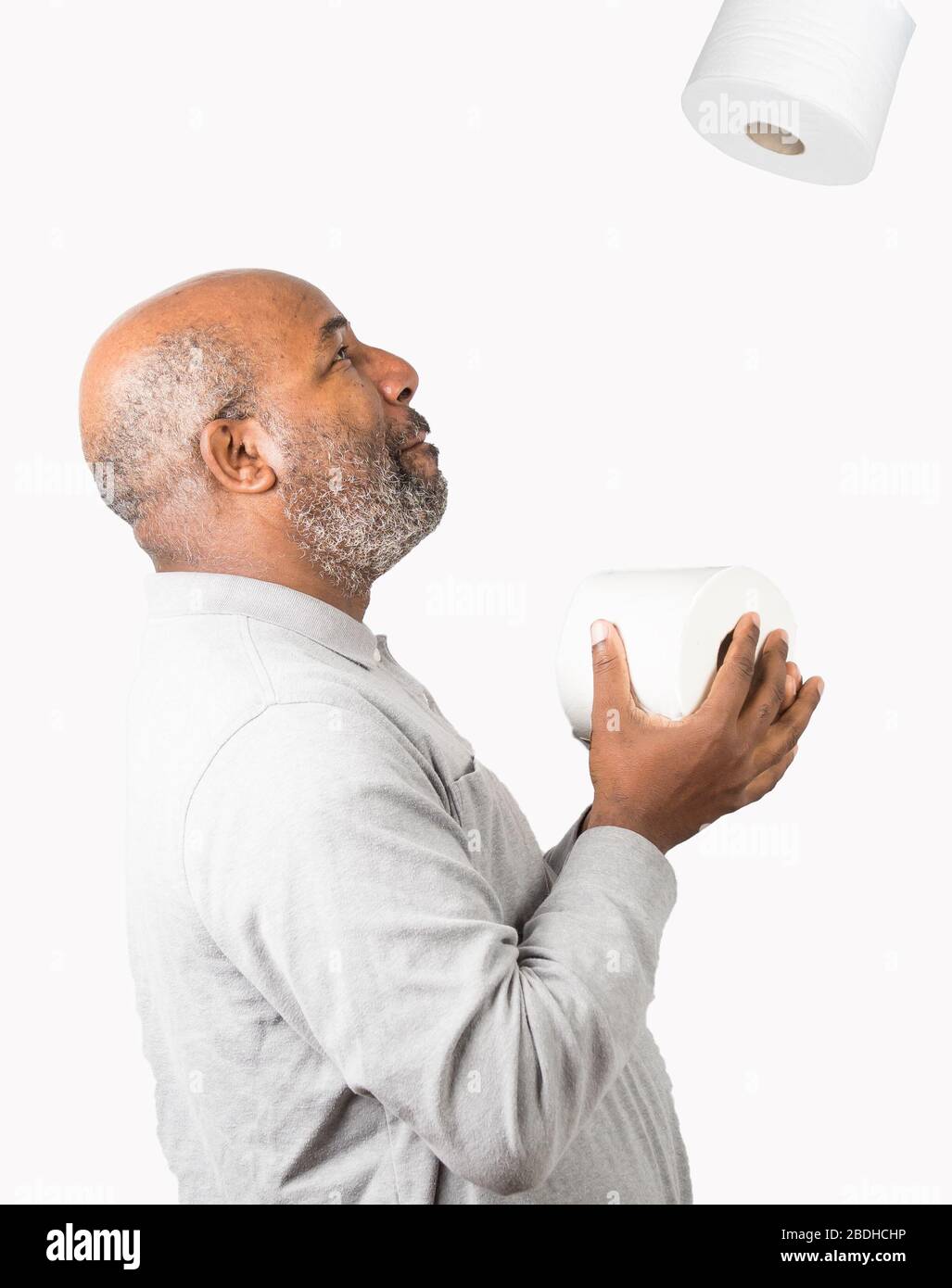 African American man with toilet paper during Corona Virus crisis. Dark Humor Stock Photo