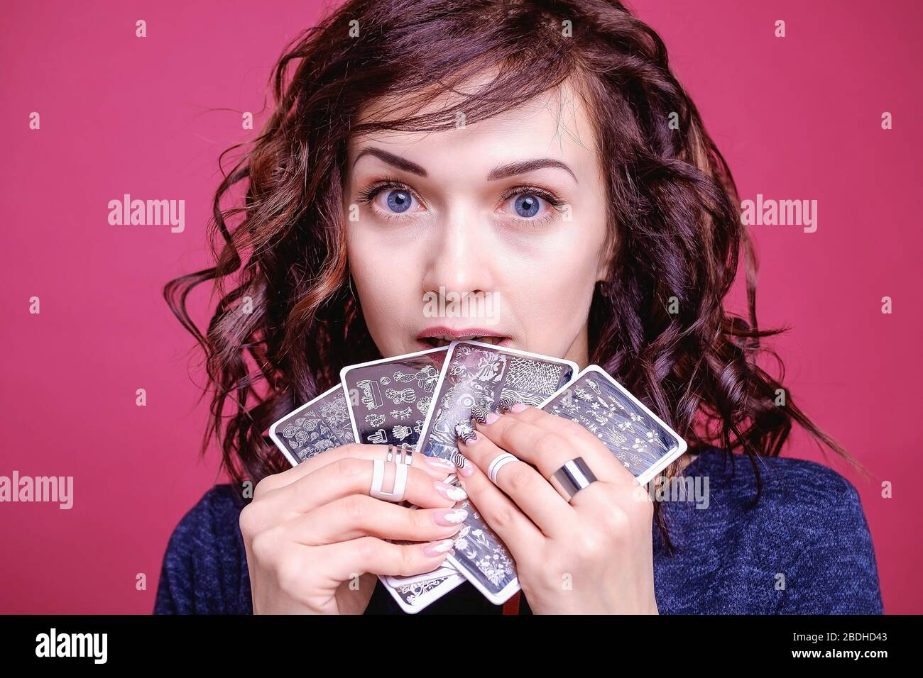 Face Of A Curly Haired Brunette Girl With Stamping Plates Closeup Portrait Of A Business Woman