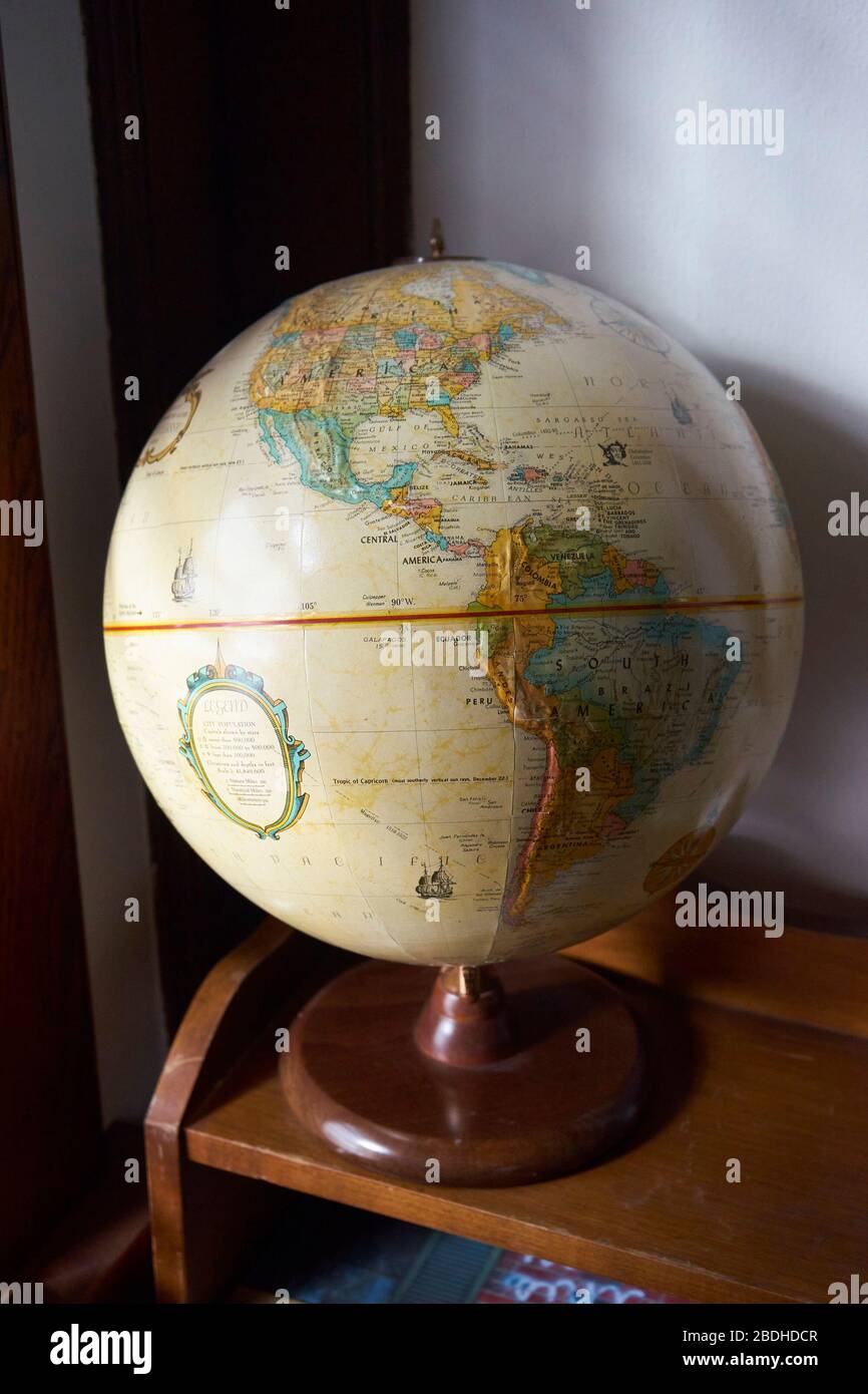 Antique globe on bookshelf Stock Photo Alamy