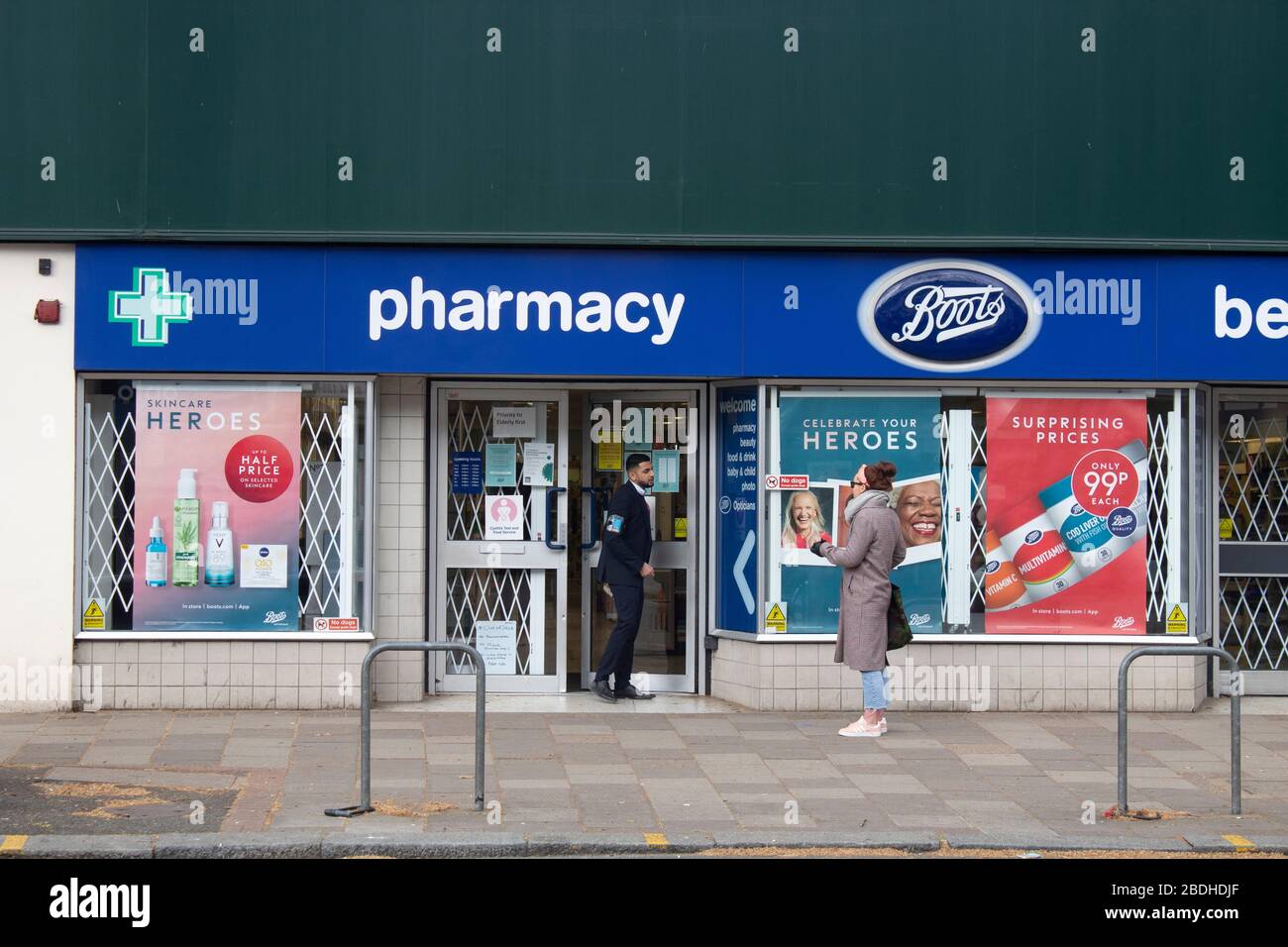 Shoppers waiting two meters apart to get into a Boots the Chemist during the Covid-19 pandemic, Chiswick, London UK Stock Photo