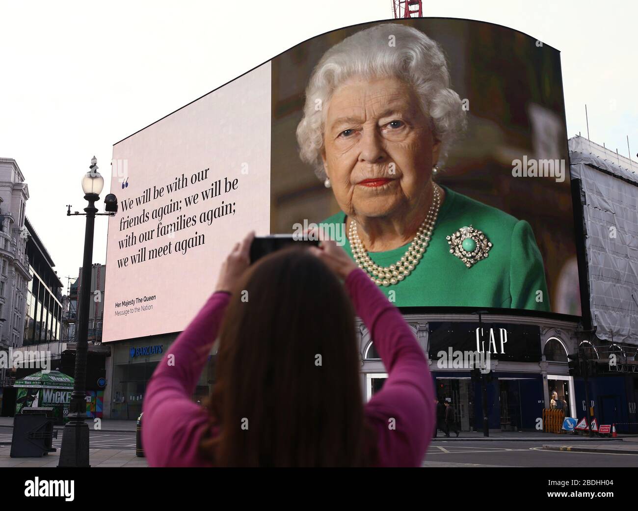 An image of Queen Elizabeth II and quotes from her broadcast on Sunday to  the UK and the Commonwealth in relation to the coronavirus epidemic are  displayed on lights in London's Piccadilly, image size:1300x1041