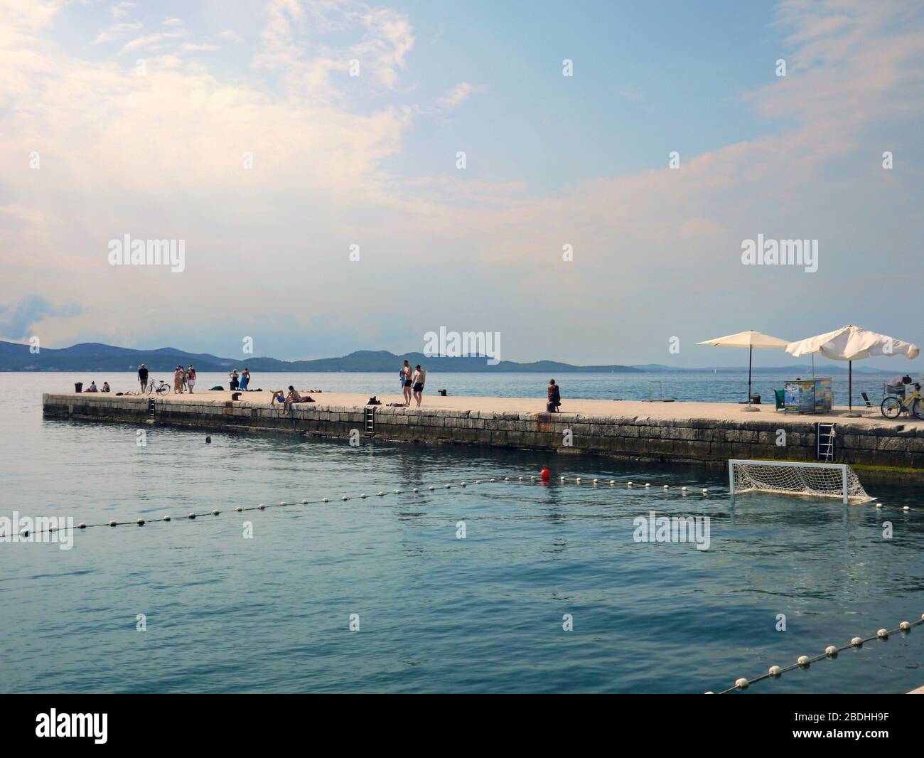 Adriatic Sea and people bathing in Zadar, Croatia Stock Photo