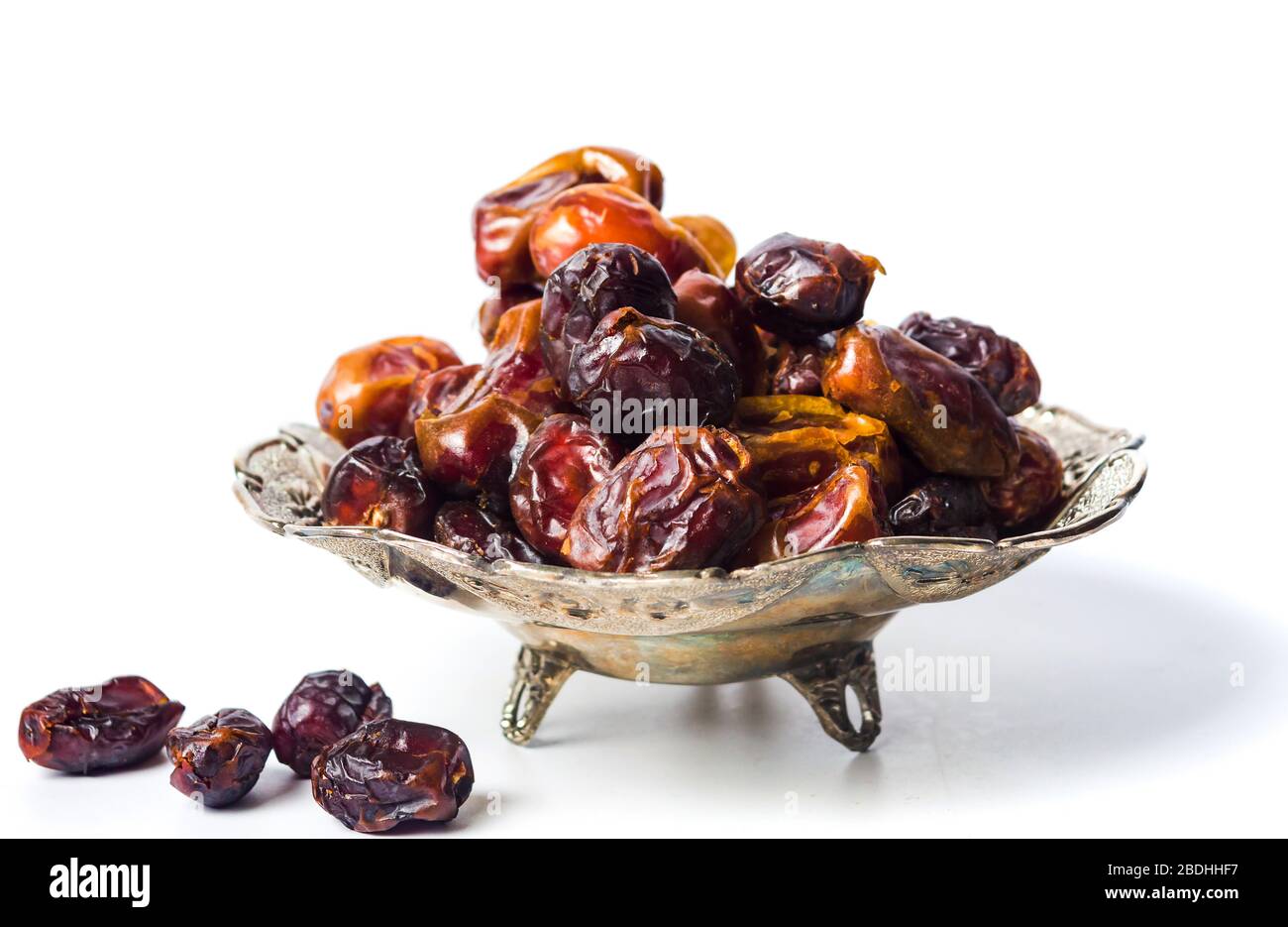 Arabian dates on a plate isolated on white background Stock Photo