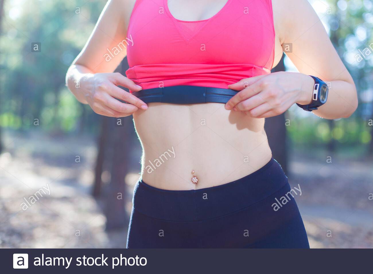 Close Up Of Girl Using Heart Rate Monitor For Workout In The Forest Or Tracking Her Weight Loss Improvement Stock Photo Alamy