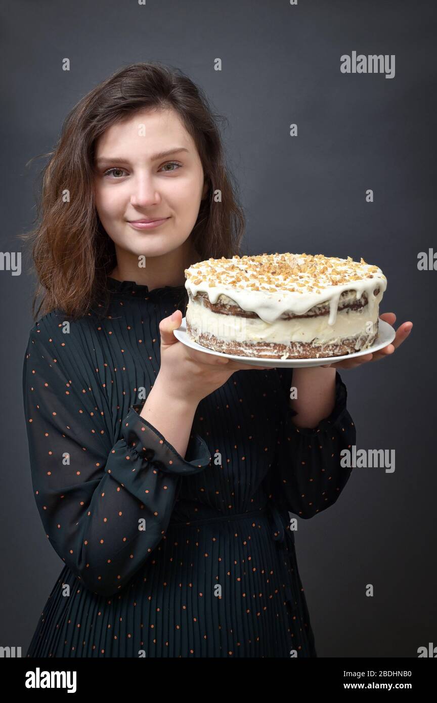Young Girl Holding Birthday Cake in Studio Stock Photo