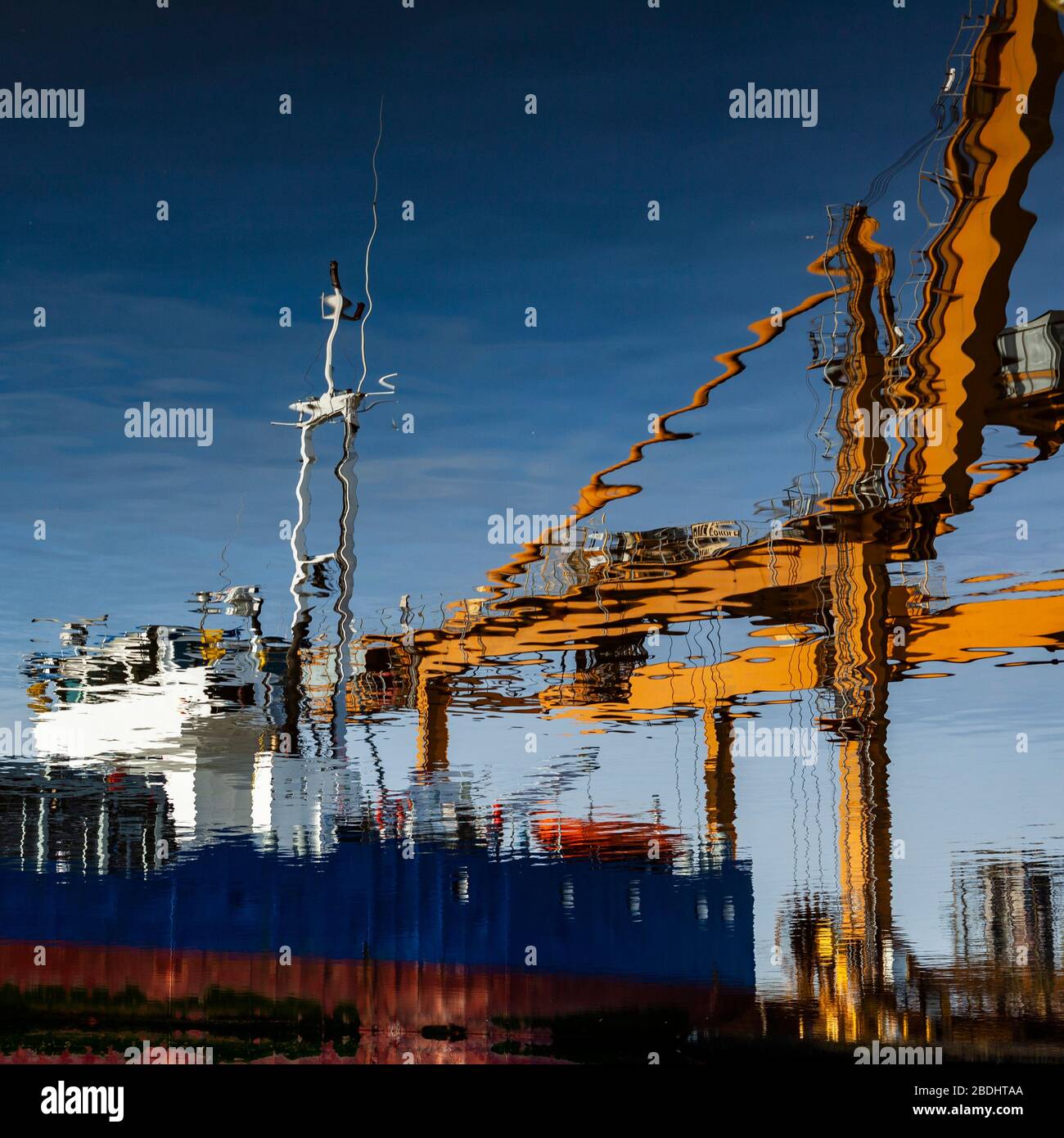Ship and crane refection in still water. Stock Photo