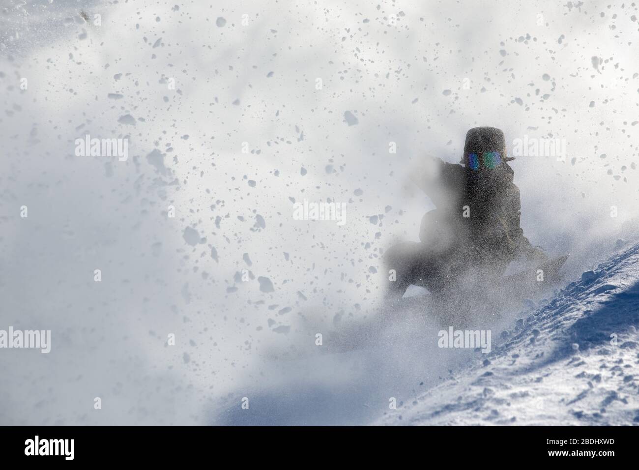 Snowboarding through snow cloud in Japan Stock Photo