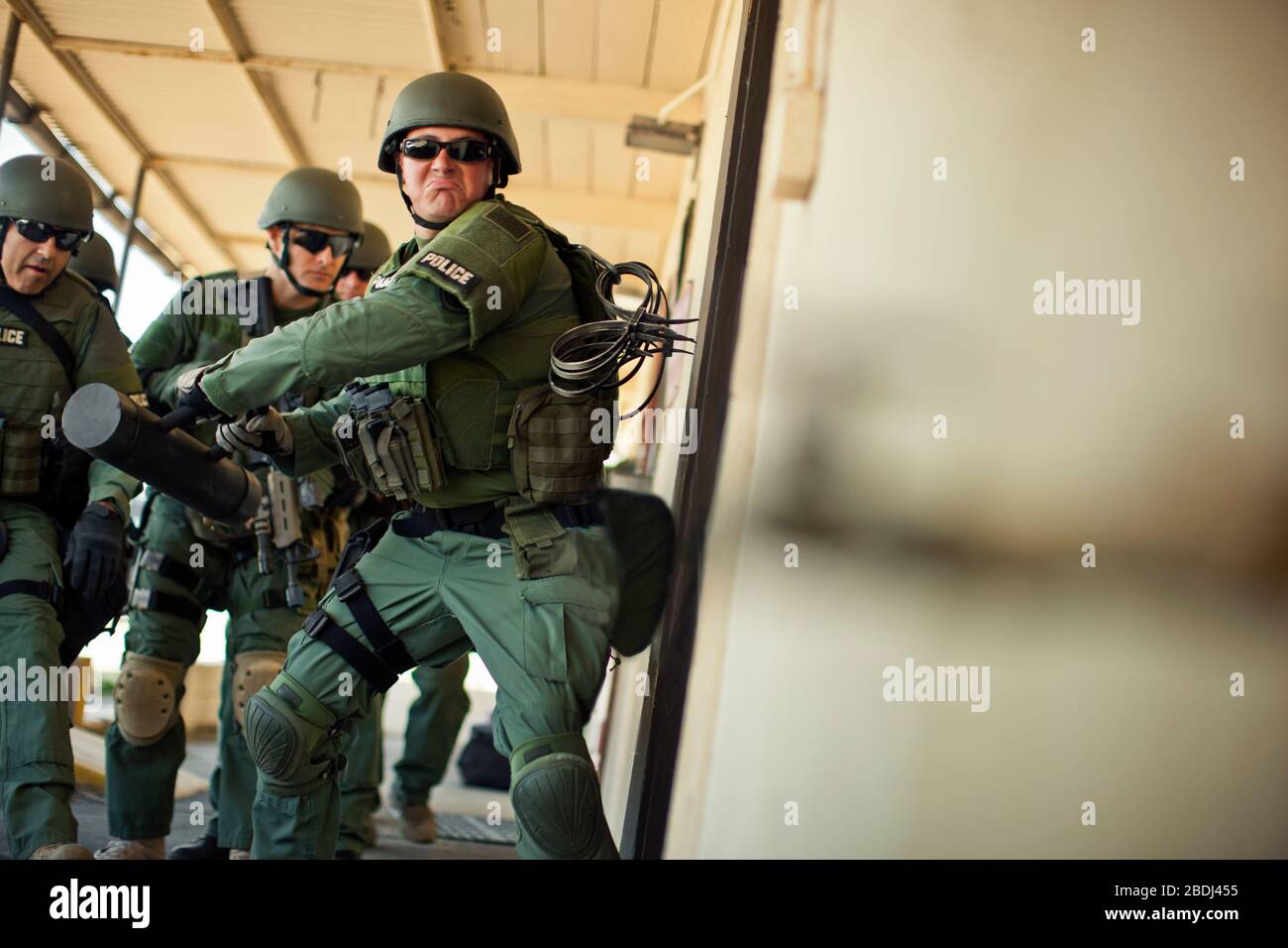 Group of police officers about to enter a building during an exercise at a training facility. Stock Photo