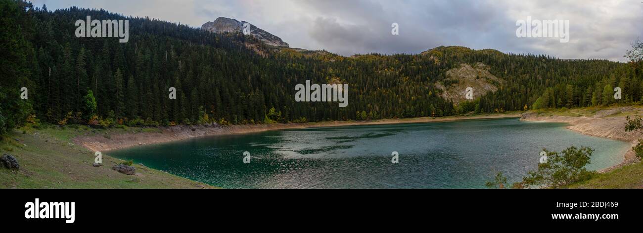 Different views of the glacial Black lake (Crno jezero), forest and mountains around in the national park Durmitor in Montenegro, Europe Stock Photo