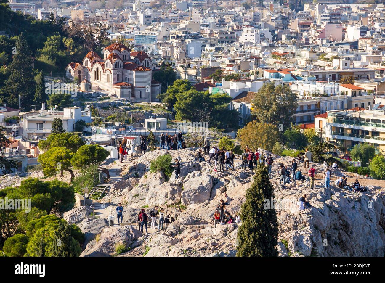 ATHENS, GREECE - DECEMBER 17, 2019: People make photos of Acropolis and Athens from Areopagus hill view point Stock Photo