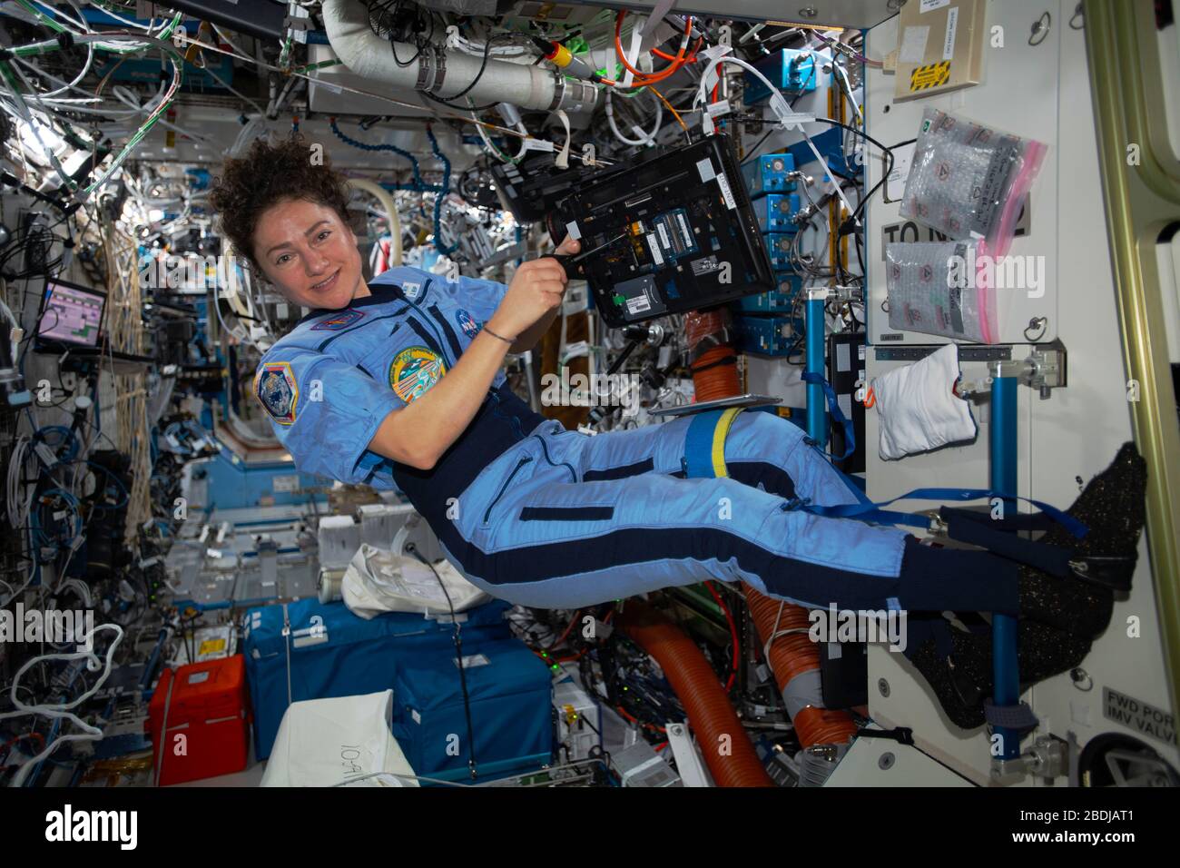 ISS - 31 March 2020 - NASA astronaut and Expedition 62 Flight Engineer Jessica Meir is pictured working on laptop computer maintenance aboard the Inte Stock Photo