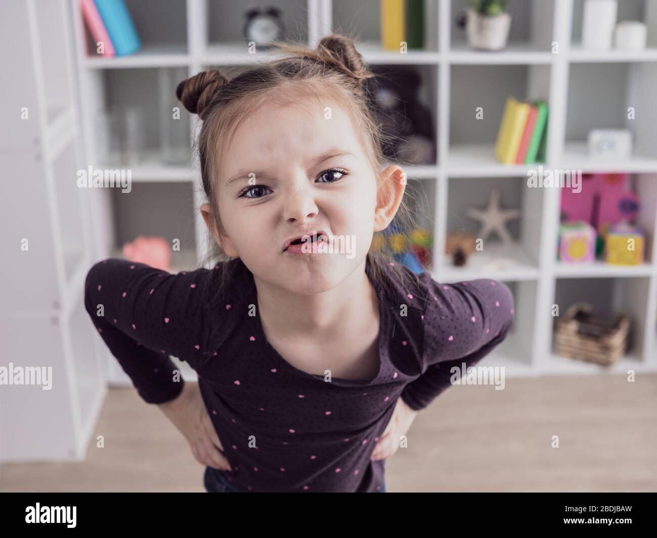 Close up portrait of little child girl with funny face expression. Stock Photo