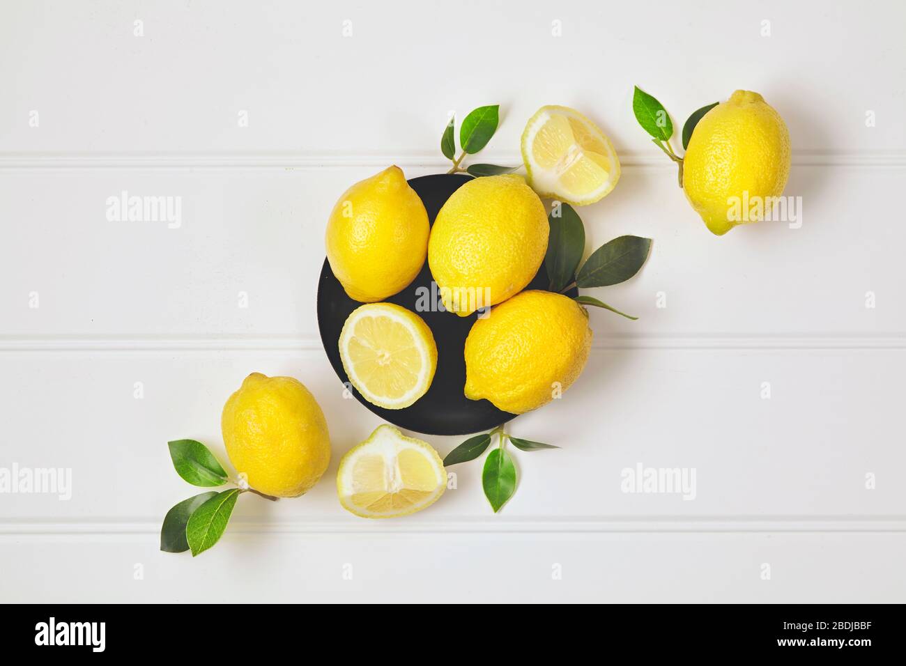 Composition with ripe lemons on white background. Close up. Stock Photo