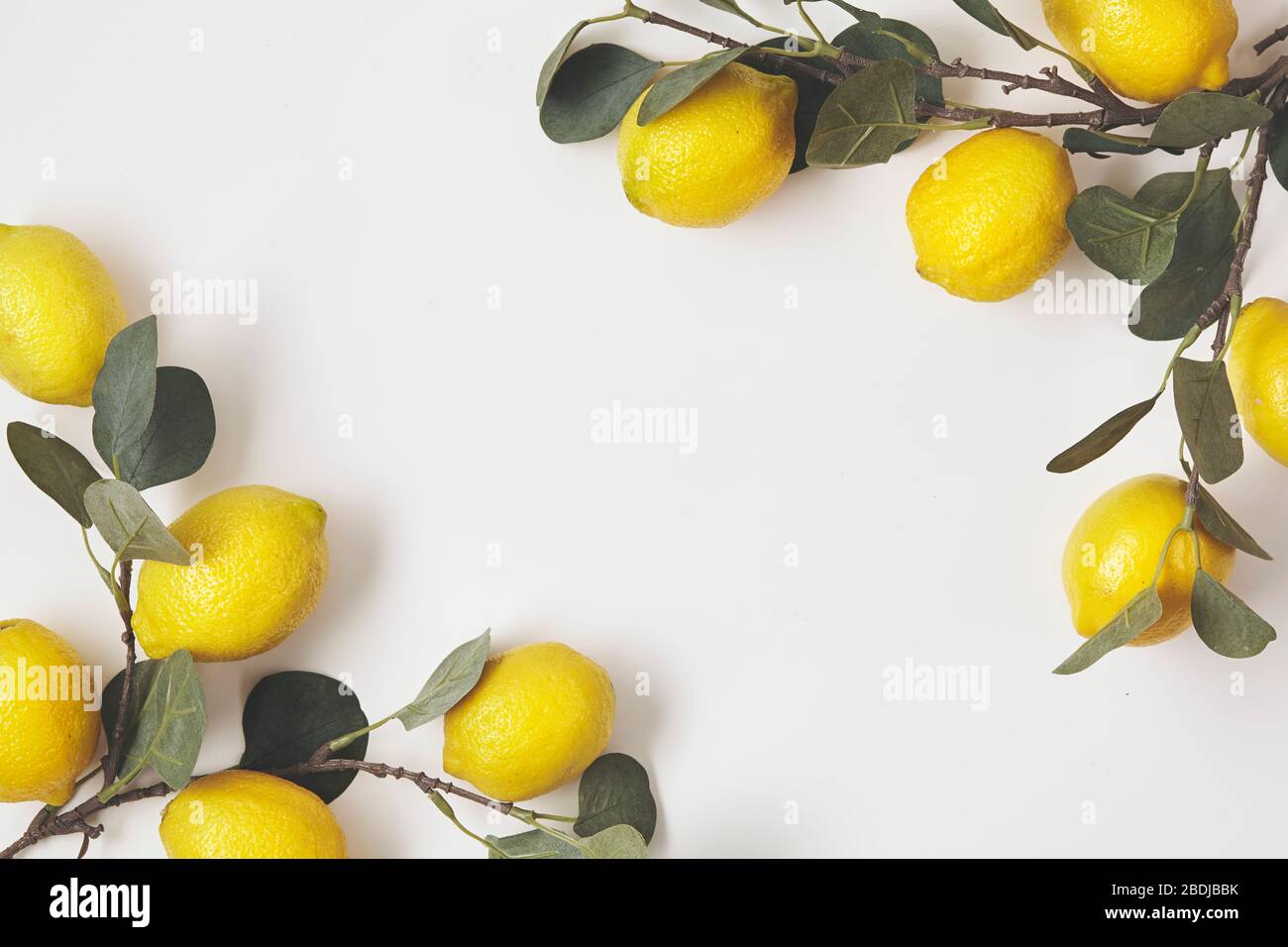 Composition with ripe lemons on white background. Close up. Stock Photo