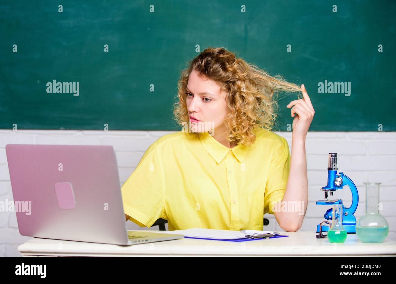 girl in classroom laboratory with computer. student with microscope and ...