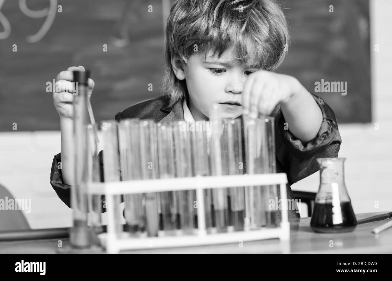 Science concept. Wunderkind experimenting with chemistry. Boy test ...