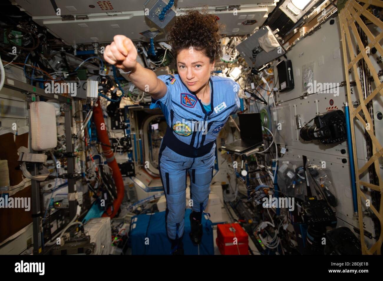 ISS - 29 March 2020 - NASA astronaut and Expedition 62 Flight Engineer Jessica Meir strikes a superhero pose in the weightless environment of the Inte Stock Photo