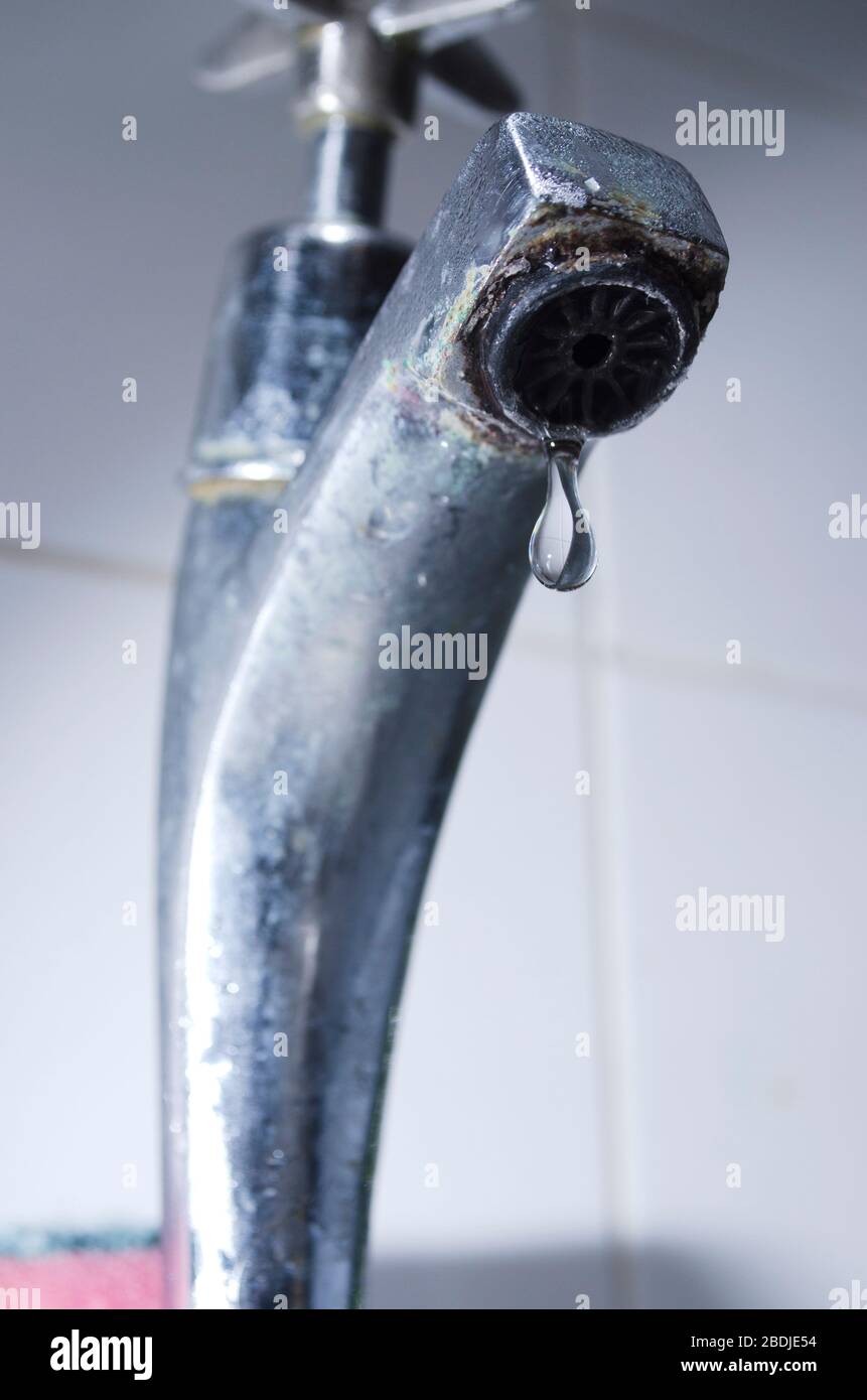 Water Dripping from Steel Faucet Stock Photo