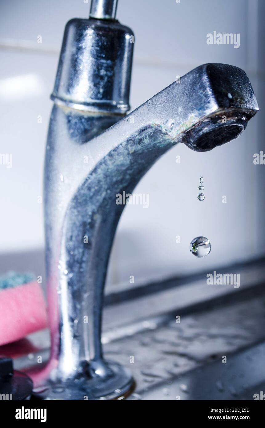 Water Dripping from Steel Faucet Stock Photo