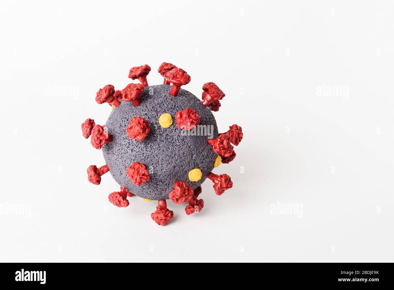 SARS-CoV-2 coronavirus model close-up on a white background. The causative agent of the disease COVID-19 Stock Photo