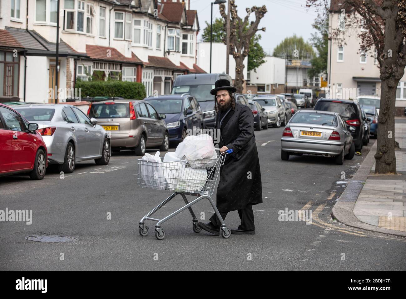 Ultra-Orthodox Jew in the Jewish Community of Stamford Hill with provisions ahead of the Passover celebrations during the COVID-19 lockdown, London Stock Photo