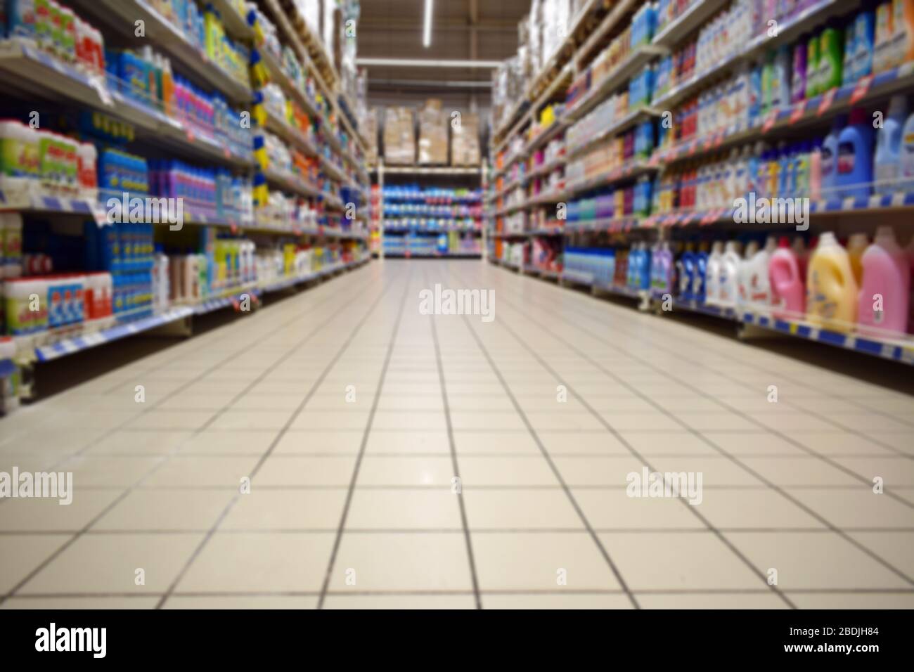 Blurred abstract background of shelf in supermarket bottom view. Department with shelves. Household chemicals in a hypermarket without people. Stock Photo