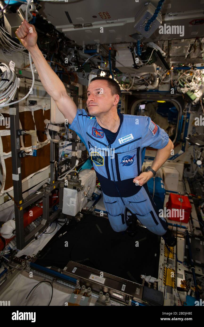 ISS - 29 March 2020 - NASA astronaut and Expedition 62 Flight Engineer Andrew Morgan strikes a superhero pose in the weightless environment of the Int Stock Photo